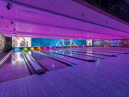 The Bowling Barn's sixteen lanes under the purple Glow Bowling lights