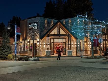 A Village storefront lit with string lights at night
