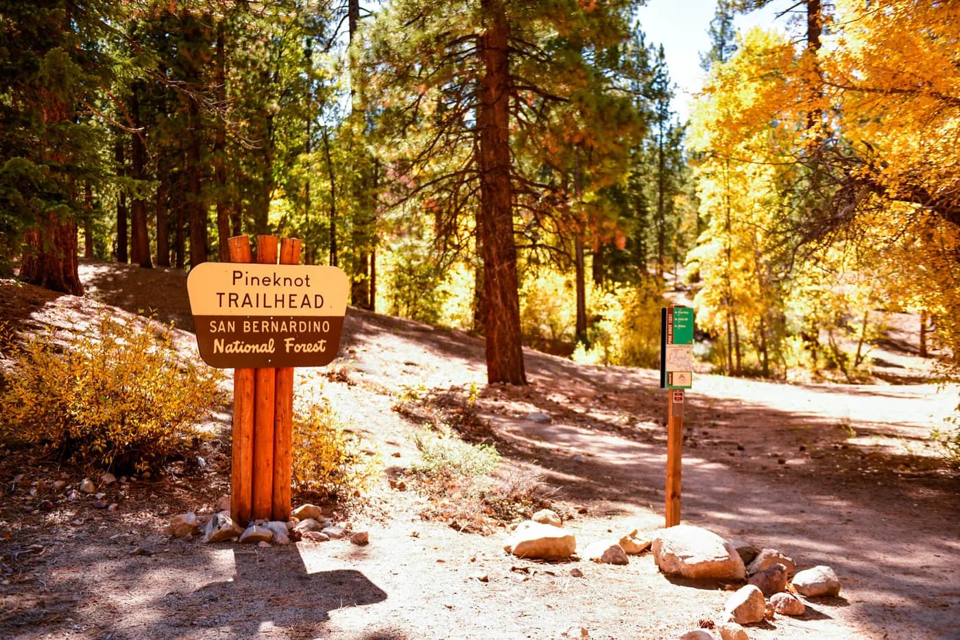 The Pine Knot trailhead sign in the San Bernardino National Forest, framed by autumn aspens
