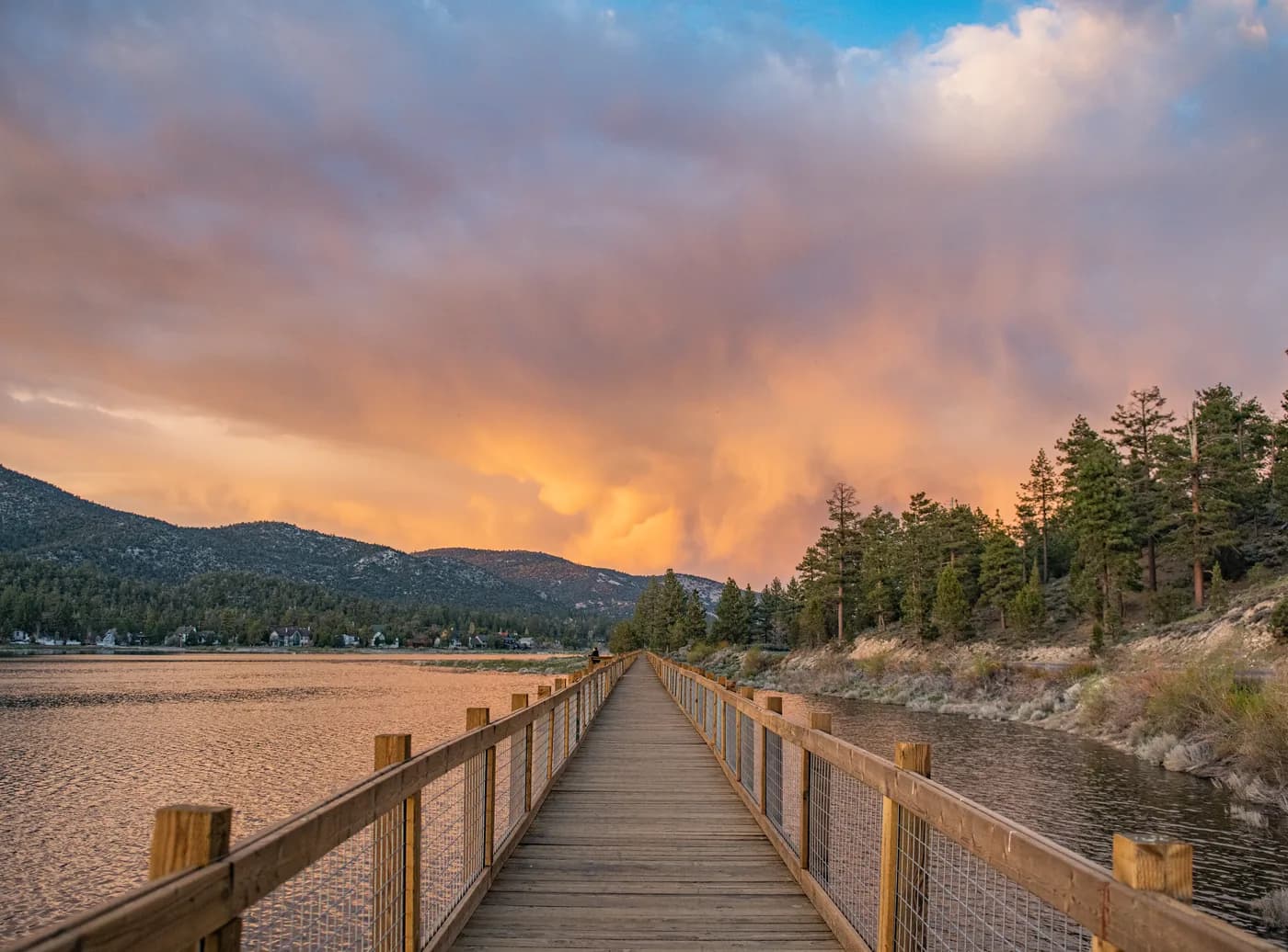 The boardwalk running straight out across the Stanfield Preserve wetland under a sunset sky